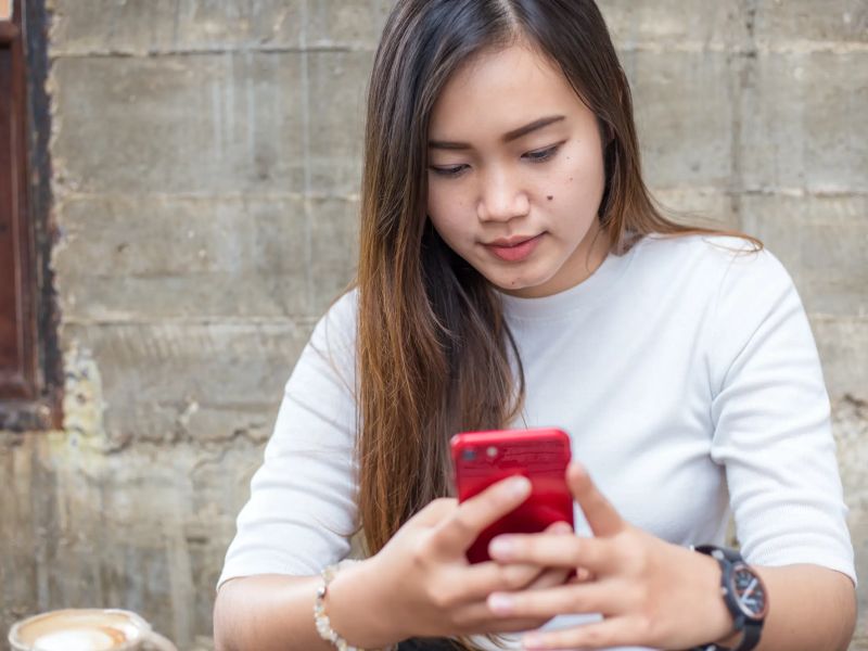 Girl Holding Phone.webp