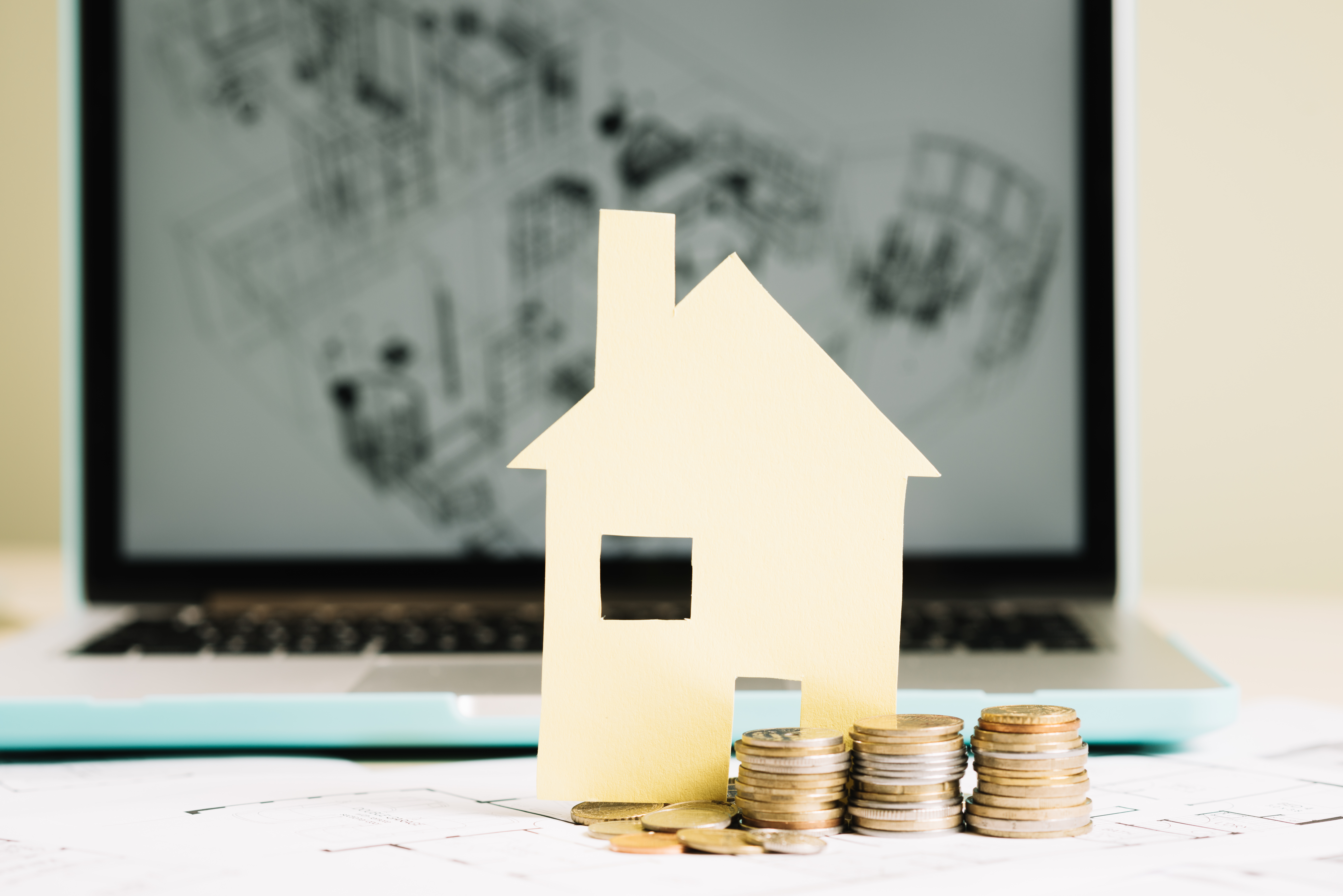 yellow-paper-house-coins-laptop.jpg